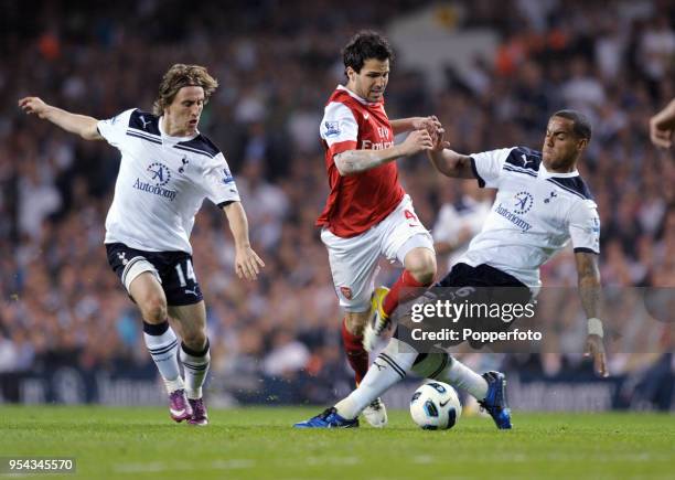 Cesc Fabregas of Arsenal is tackled by Tom Huddlestone of Tottenham Hotspur watched by Luka Modric during the Barclays Premier League match between...