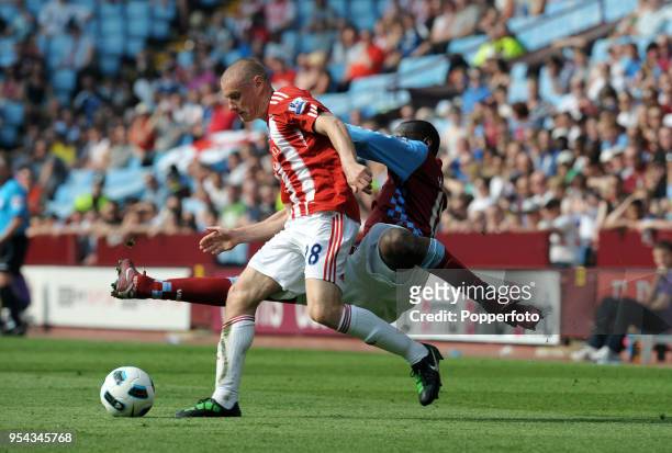 Andy Wilkinson of Stoke City evades Emile Heskey of Aston Villa during the Barclays Premier League match between Aston Villa and Stoke City at Villa...