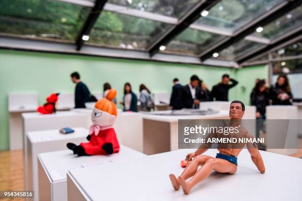 Visitors look at items presented during the opening of the Museum of Broken Relationships in Kosovo, on May 3, 2018. - The Museum of Broken...