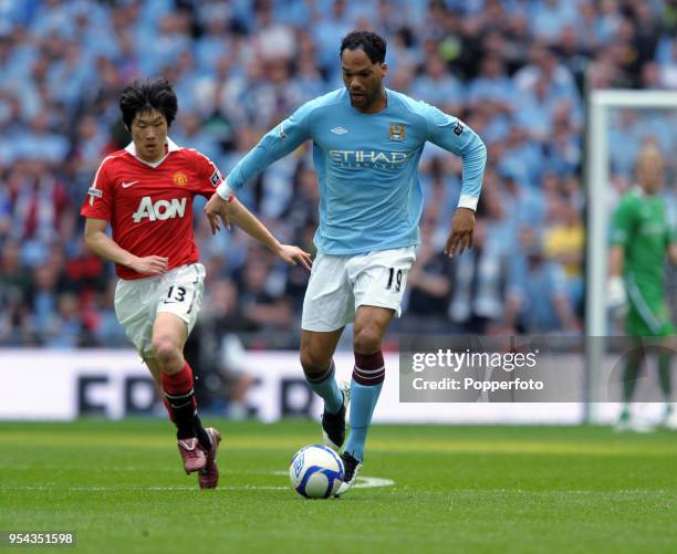 Ji-Sung Park of Manchester United and Joleon Lescott of Manchester City in action during the FA Cup sponsored by E.ON semi final match between...