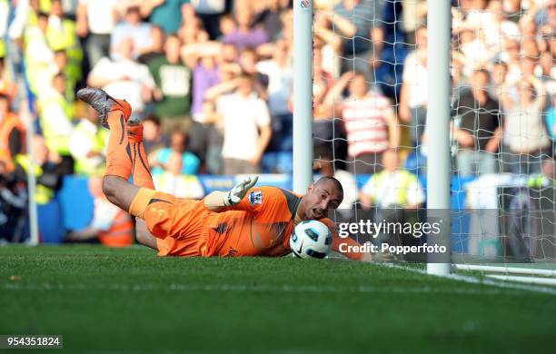 Tottenham Hotspur goalkeeper Heurelho Gomes tries to stop the ball going over the line during the Barclays Premier League match between Chelsea and...