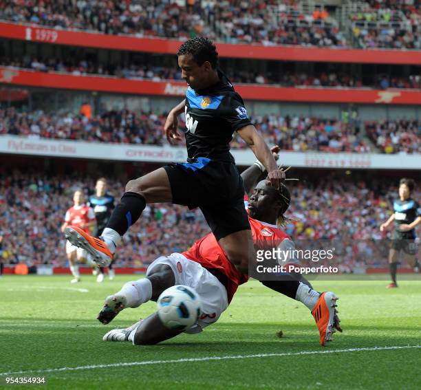 Nani of Manchester United is tackled by Bacary Sagna of Arsenal during the Barclays Premier League match between Arsenal and Manchester United at...