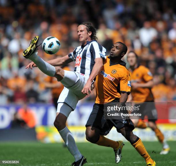 Sylvan Ebanks-Blake of Wolves and Jonas Olsson of West Bromwich Albion in action during the Barclays Premier League match between Wolverhampton...