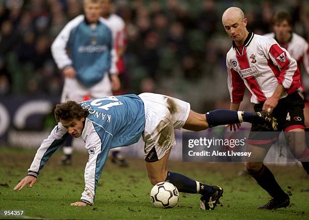 Andrei Kanchelskis of Manchester City falls under the challenge of Chris Marsden of Southampton during the FA Carling Premiership match at Maine Road...
