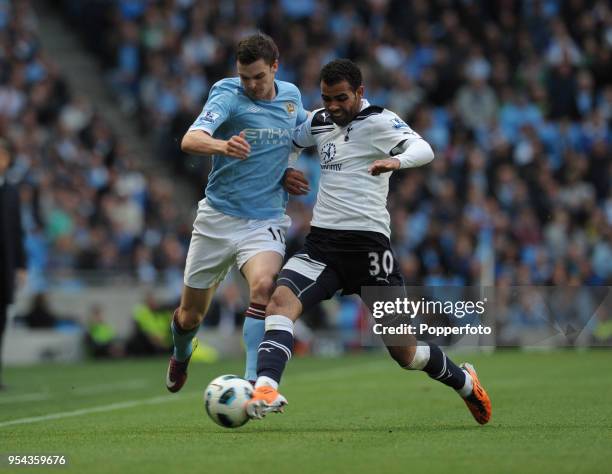 Adam Johnson of Manchester City and Sandro of Tottenham Hotspur battle for the ball during the Barclays Premier League match between Manchester City...