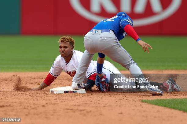 Cleveland Indians third baseman Jose Ramirez is safe at second base ahead of the tag of Toronto Blue Jays infielder Lourdes Gurriel Jr. During the...