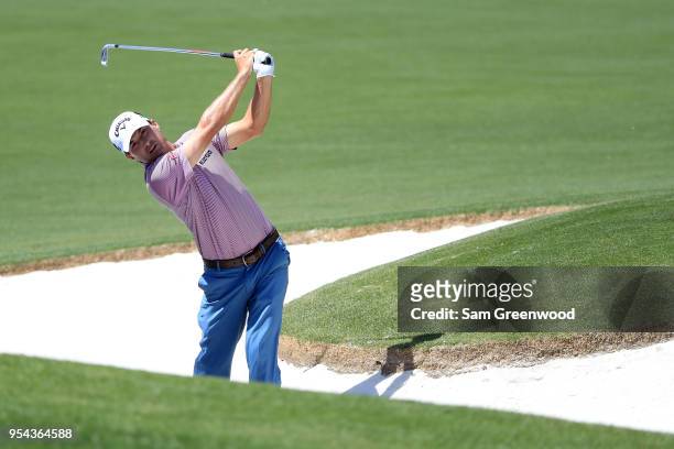 Kevin Kisner plays a shot from a bunker on the 16th hole during the first round of the 2018 Wells Fargo Championship at Quail Hollow Club on May 3,...