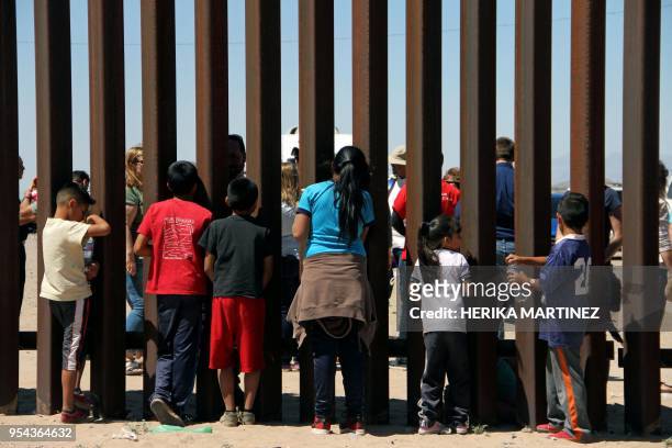 Children from the Anapra area observe a binational prayer performed by a group of religious presbyters on the border wall between Ciudad Juarez,...
