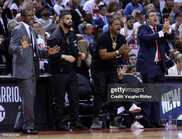 Head Coach Dwane Casey of the Toronto Raptors and singer Drake react in the second half of Game One of the Eastern Conference Semifinals against the...