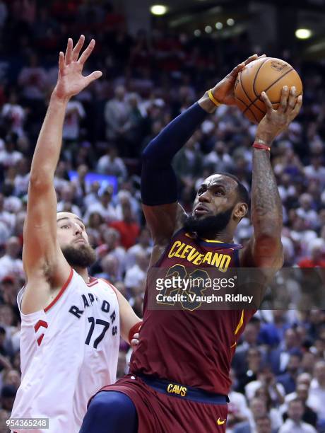 LeBron James of the Cleveland Cavaliers shoots the ball as Jonas Valanciunas of the Toronto Raptors defends in the second half of Game One of the...
