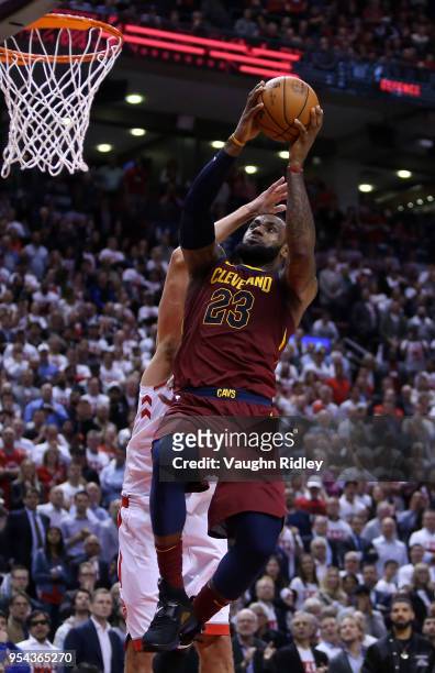 LeBron James of the Cleveland Cavaliers shoots the ball as Jonas Valanciunas of the Toronto Raptors defends in the second half of Game One of the...