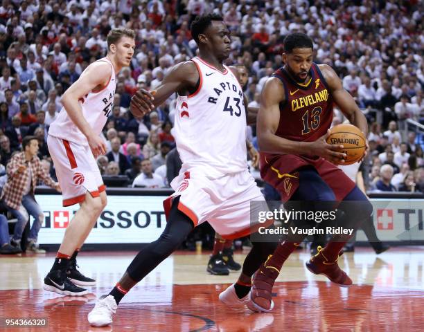 Tristan Thompson of the Cleveland Cavaliers dribbles the ball as Pascal Siakam of the Toronto Raptors defends in the second half of Game One of the...