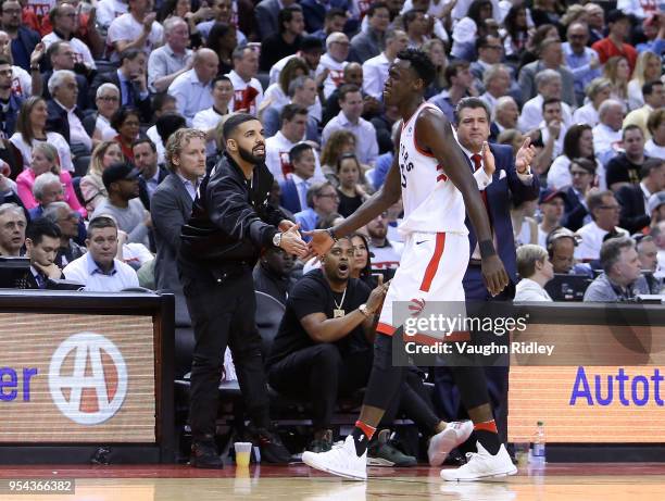 Singer Drake high fives Pascal Siakam of the Toronto Raptors in the second half of Game One of the Eastern Conference Semifinals against the...