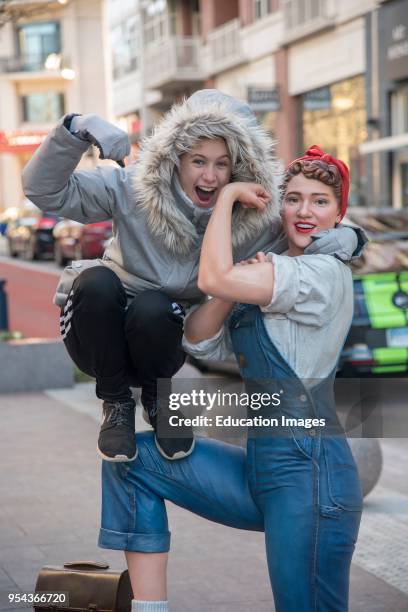 Young girl with statue of Rosie the Riveter in National Harbor; Maryland