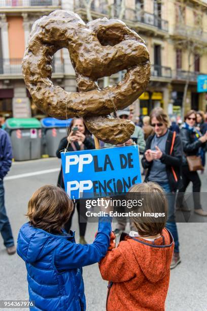 Barcelona, Catalonia, Two kids in the demonstration for fair pensions. Pensioners and young people from all around Spain took part in a nationwide...