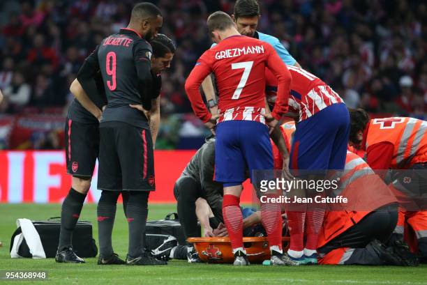 Alexandre Lacazette of Arsenal and Antoine Griezmann of Atletico Madrid worries for their teammate with the French team Laurent Koscielny of Arsenal...