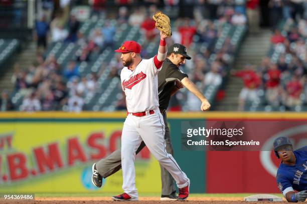 Cleveland Indians second baseman Jason Kipnis holds up the baseball as umpire Pat Hoberg calls out Toronto Blue Jays infielder Yangervis Solarte at...