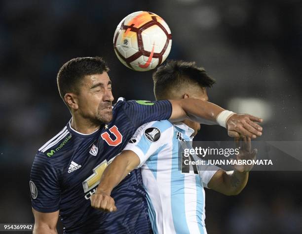 Chile's Universidad de Chile defender Gonzalo Jara vies for the ball with Argentina's Racing Club midfielder Federico Zaracho during their Copa...