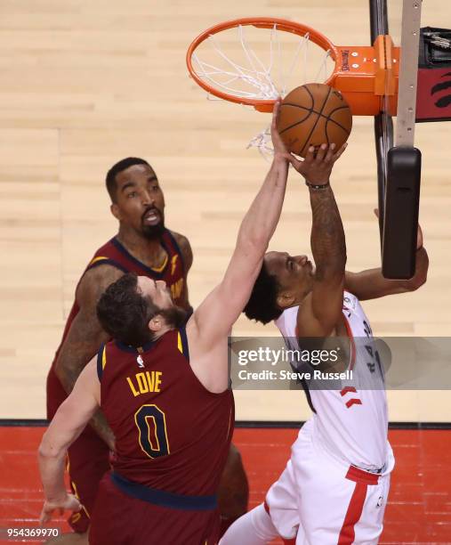 Cleveland Cavaliers center Kevin Love denies Toronto Raptors guard DeMar DeRozan under the basket as the Toronto Raptors play the Cleveland Cavaliers...