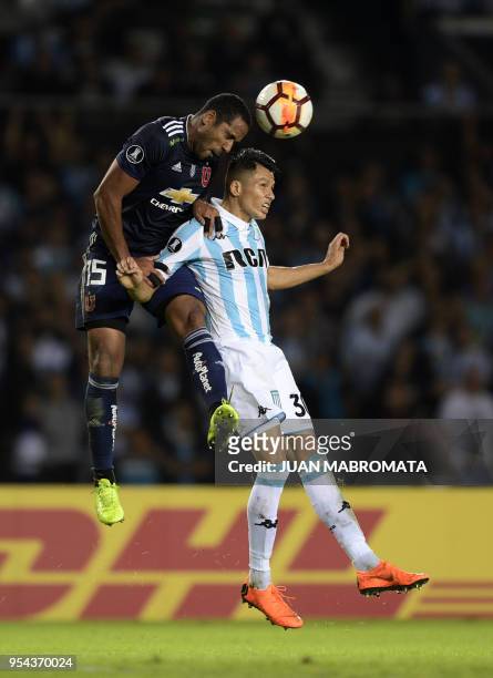 Chile's Universidad de Chile midfielder Jean Beausejour jumps for a header with Argentina's Racing Club defender Leonardo Sigali during their Copa...