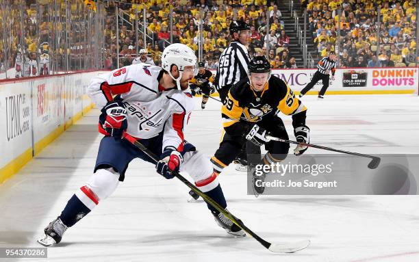 Michal Kempny of the Washington Capitals handles the puck against Jake Guentzel of the Pittsburgh Penguins in Game Four of the Eastern Conference...