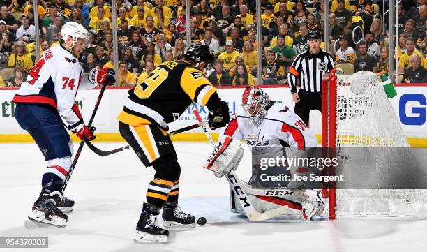 Braden Holtby of the Washington Capitals makes a save against Jake Guentzel of the Pittsburgh Penguins in Game Four of the Eastern Conference Second...