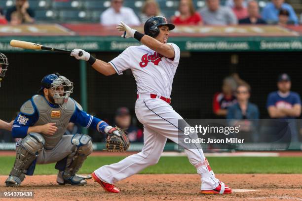 Michael Brantley of the Cleveland Indians hits an RBI single to tie the game during the eighth inning against the Toronto Blue Jays at Progressive...