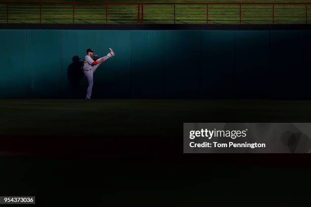 Martinez of the Boston Red Sox stretches in the outfield before taking on the the Texas Rangers at Globe Life Park in Arlington on May 3, 2018 in...