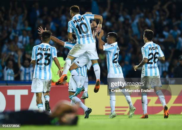 Alejandro Donatti of Racing Club celebrates with teammates after scoring the first goal of his team during a group stage match between Racing Club...
