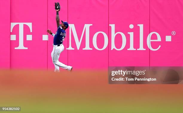 Delino DeShields of the Texas Rangers pulls in a fly ball hit by Eduardo Nunez of the Boston Red Sox in the top of the second inning at Globe Life...