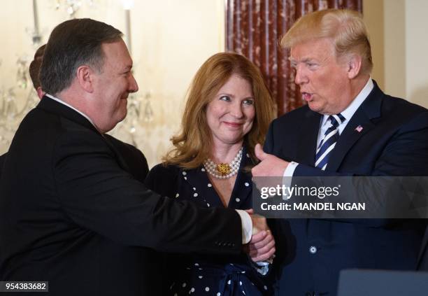 President Donald Trump takes gives the thumb-up to US Secretary of State Mike Pompeo as Pompeo's wife Susan looks on during his ceremonial...