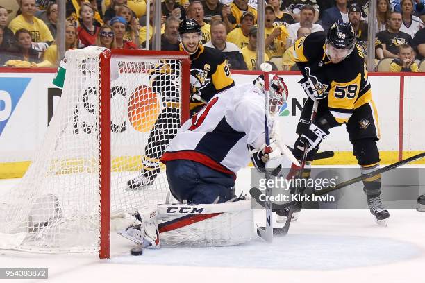 Jake Guentzel of the Pittsburgh Penguins slides the puck past Braden Holtby of the Washington Capitals for a goal during the second period in Game...