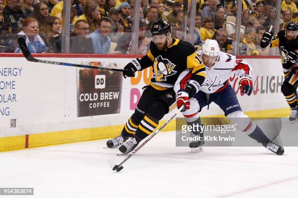 Riley Sheahan of the Pittsburgh Penguins and Evgeny Kuznetsov of the Washington Capitals battle for control of the puck during the second period in...