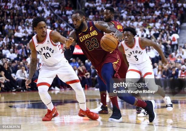 LeBron James of the Cleveland Cavaliers dribbles the ball as DeMar DeRozan of the Toronto Raptors defends in the second half of Game Two of the...