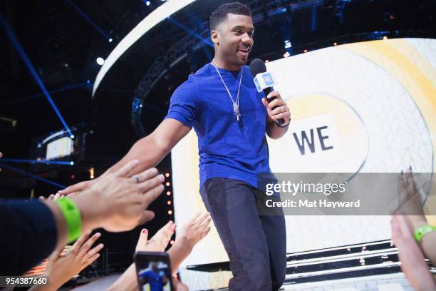 Seattle Seahawks NFL Quarterback Russell Wilson speaks on stage during WE Day at KeyArena on May 3, 2018 in Seattle, Washington.