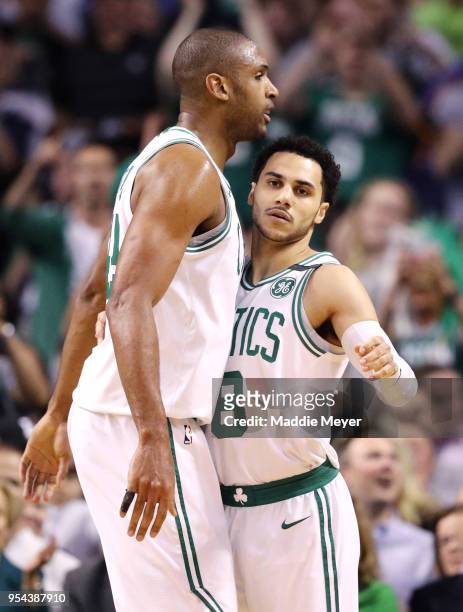 Al Horford of the Boston Celtics celebrates with Shane Larkin after scoring against the Philadelphia 76ers during the first quarter of Game Two of...