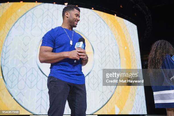 Seattle Seahawks NFL Quarterback Russell Wilson speaks on stage during WE Day at KeyArena on May 3, 2018 in Seattle, Washington.