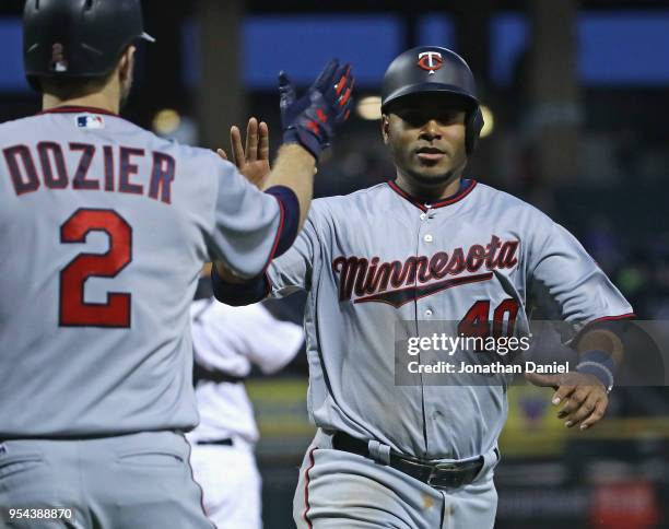 Gregorio Petit of the Minnesota Twins is congratulated by Brian Dozier after scoring a run in the 3rd inning against the Chicago White Sox at...