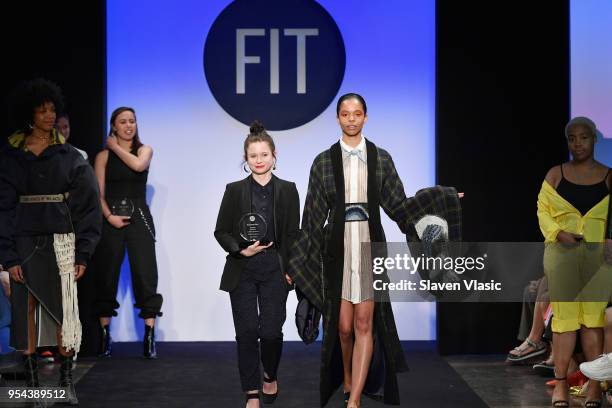 Critic Award winner Lauren Barkley walks with a model on the runway during the 2018 Future Of Fashion Runway Show at The Fashion Institute of...