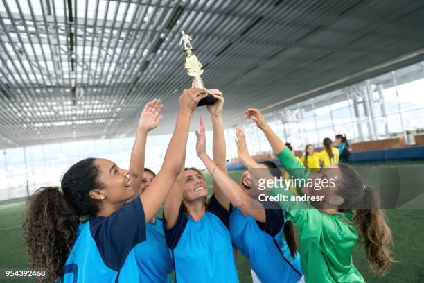 female soccer players celebrating they just won the tournament with a trophy - holding trophy stock pictures, royalty-free photos & images
