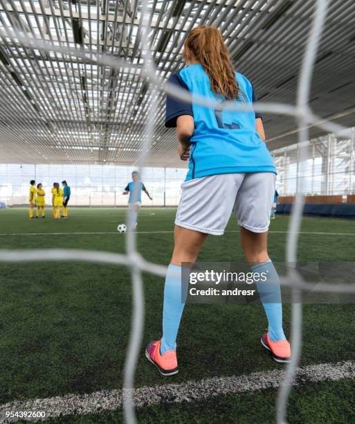 african american soccer player kicking the ball at the goal - woman goalie stock pictures, royalty-free photos & images