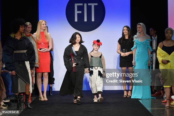 Critic Award winner Michelle Yoon walks the runway with a model during the 2018 Future Of Fashion Runway Show at The Fashion Institute of Technology...