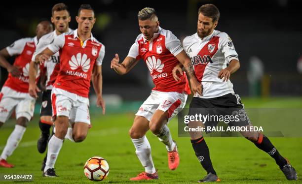 Argentina's River Plate player Leonardo Ponzio vies for the ball with Colombia's Independiente Santa Fe player Juan Roa during their Copa...