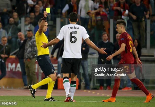 Referee Damir Skomina of Slovenia gives a yellow card to Dejan Lovren of Liverpool after he pushed Stephan El Shaarawy of AS Roma during the UEFA...