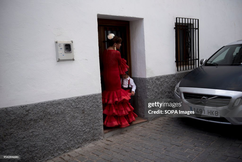 A woman with her son wearing a typical Flamenco dress seen...