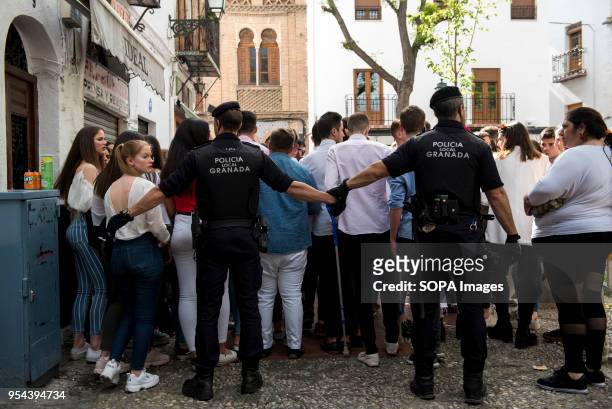 Policemen try to empty Plaza Larga Square of people during the Dia de las Cruces festival."El día de la Cruz or Día de las Cruces is one of the most...