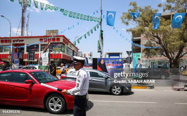 Picture taken on April 30, 2018 shows the flags of the Iraqi Turkmen hanging next to the Patriotic Union of Kurdistan flags , above the banners and...