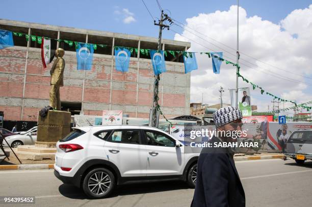 Picture taken on April 30, 2018 shows the flags of the Iraqi Turkmen hanging next to other banners and flags for candidates and lists in the upcoming...