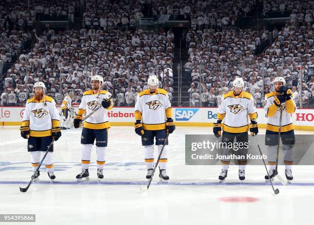 Ryan Ellis, Roman Josi, Austin Watson, Colton Sissons and Nick Bonino of the Nashville Predators stand on the ice prior to puck drop against the...