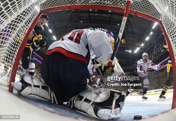 Jake Guentzel of the Pittsburgh Penguins s scores against Braden Holtby of the Washington Capitals in Game Four of the Eastern Conference Second...